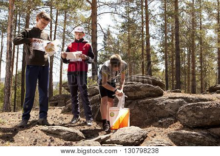 RUSSIA, ULAN-UDE - MAY 22, 2016: Russian Azimut - 2016. Orienteering competition is held annually in the Buryatia region. People at at control point at orienteering course.