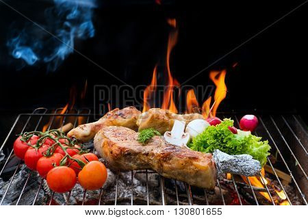 Grill concept. Assorted delicious grilled meat with vegetable over the coals on a barbecue