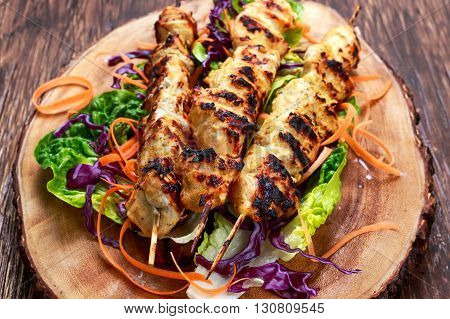 Roast Chicken filet kebab on bamboo sticks.