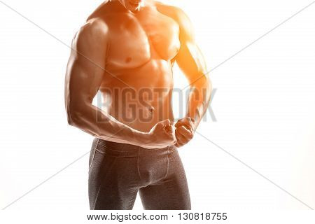 Close-up strong bodybuilder man posing with perfect abs, houlders, biceps, triceps and chest. Isolated on white background Whith solar flare