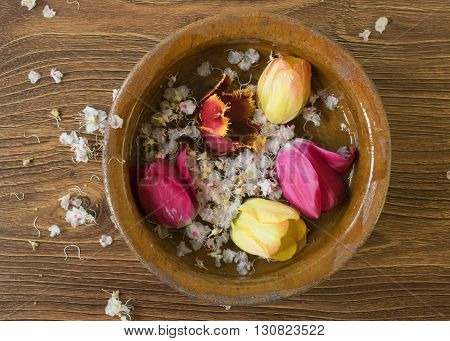 Old Bowl With Flowers Tulips On The Wooden Table