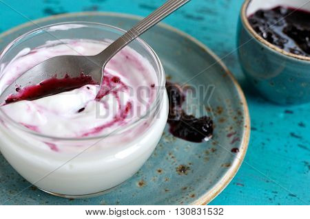 Jogurt with blueberry jam in a glass bowl