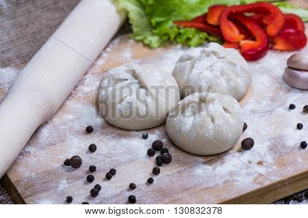 Caucasuan cuisine - Khinkali with meat served green koriander leaves.