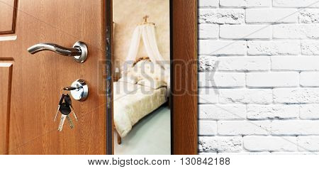 Half opened door to a bedroom. Door handle, door lock. Lounge door half open. Opening door. Welcome, privacy concept. Entrance to the room. Door at white brick wall, modern interior design.