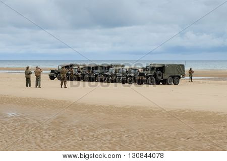 Omaha Beach, France, June 4th 2014: people and military vehicles at Omaha beach to celebrate the anniversary of d-day allied debarquement in Normandy.