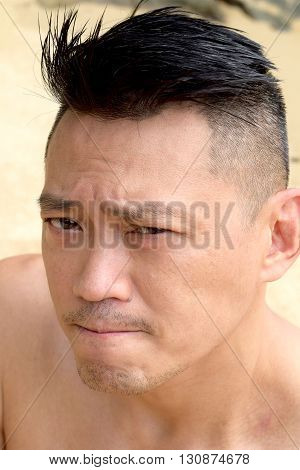 Asian Man posing outdoor topless looking at the camera
