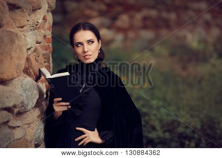 Beautiful Dark Princess Reading a Book Outside