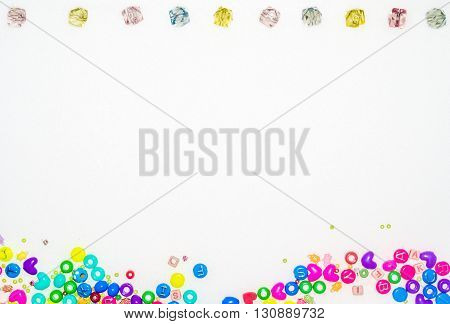 Fake jewels and plastic gadgets as a frame for a white copy space