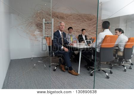business people group brainstorming on meeting and businessman presenting ideas and projects oon laptop and tablet computer