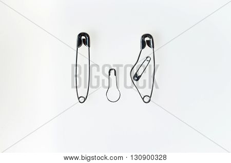 family of safety pins with pregnant mother and father and a son by her at her side