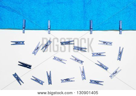 composition with clothes pegs and a fake sun and sky