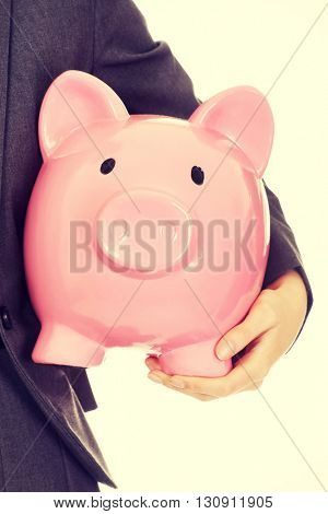 Young business woman holding piggybank
