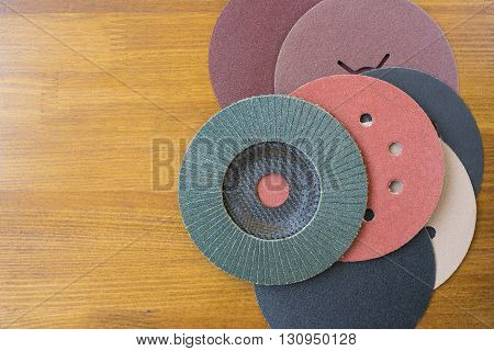 Abrasive disks for metal and stonewood grinding cutting. Set of abrasive materials on wooden background vertical view.