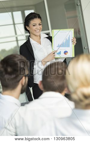 Young successful business woman presenting the results of the latest project she has been workng on