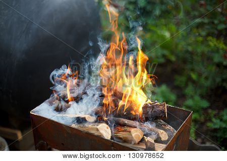 Burning wood in a brazier. Fire, flames from wood ember for grill or bbq
