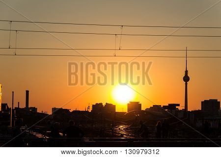 people berlin skyline and tv tower at sunset
