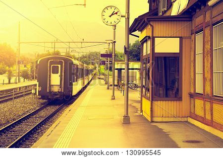 Last train moves away at sunset time.