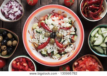 Shopska salad with cheese, tomato, cucumber, onion, olives and chili peppers