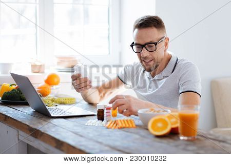 Biohack Your Brain. Smart Skillful Thoughtful Man Searching For Biohacking Supplements While Using L