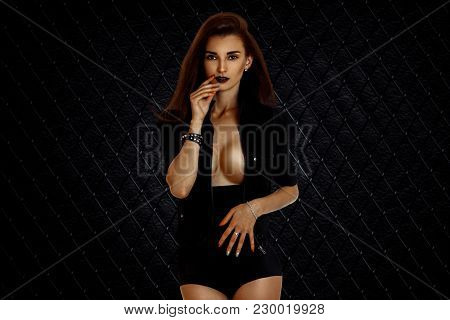 Hot Beautiful Girl With Bare Chest Faces The Camera With Unfastened Jacket Isolated On White Backgro
