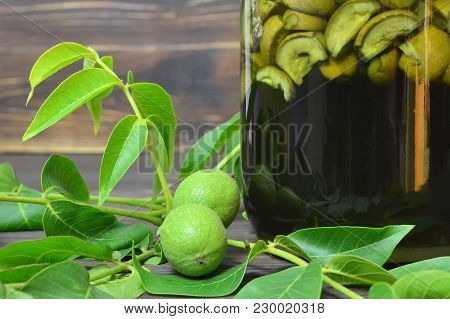 Preparing Green Walnut Liqueur Nocino, Horizontal Image