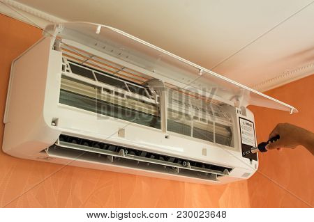 Repairing Air Conditioner That Is On The Wall With The Help Of Screwdriver