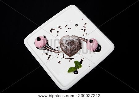 Dessert Fondan Chocolate With Ice-cream On A White Plate On A Black Background. Exquisite French Cho