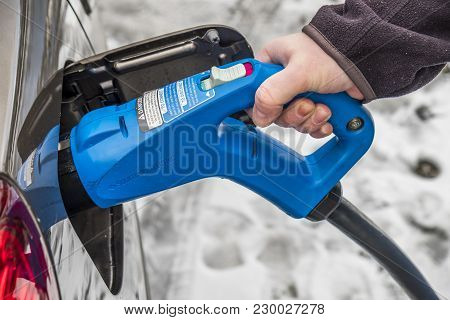 Limburg , Germany - February 11 2018 : Man Charging His Electric Car In The Winter