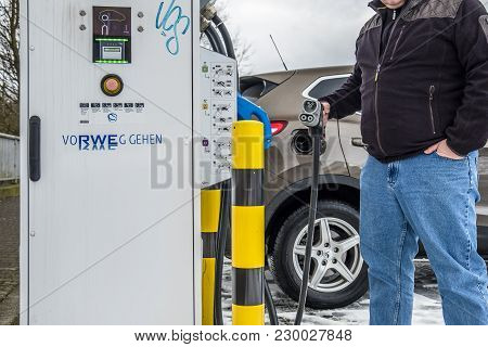 Limburg , Germany - February 11 2018 : Man Charging His Electric Car In The Winter