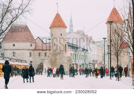 Tallinn, Estonia - December 3, 2016: People Walking Near Christmas Xmas Market On Background Of Viru