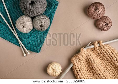 Grey And Brown Ball Wool And Knitting On Needles On Beige Background. Knitting As A Kind Of Needlewo
