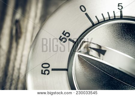 55 Minutes - Macro Of An Analog Chrome Kitchen Timer On Wooden Table