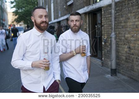 London, Uk - April 22, 2016: Two Men In White Shirts Go By Brik Lane