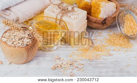 Honeycomb, Sea Salt, Oats And Handmade Soap With Honey On White Rustic Wooden Background. Natural In
