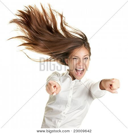 happy crazy excited woman screaming and pointing at camera with wild long hair in the wind. Beautiful ecstatic mixed race Caucasian Asian female model.
