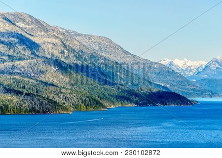 Fantastic view over ocean, snow mountain and rocks at Sechelt inlet in Vancouver, Canada.
