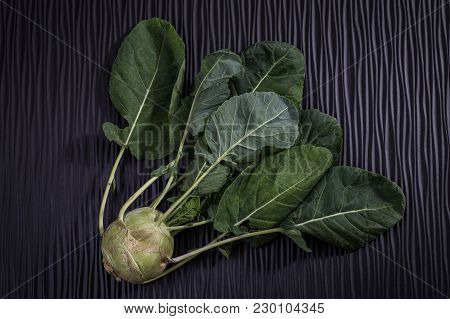 Ripe Turnip With Leaves On A Wooden Black Background. Close Up
