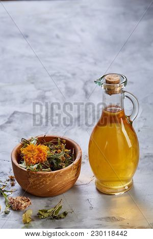Spa Still Life With Flowers In Wooden Bowl And Two Oil Jars On Light Textured Background, Top View, 