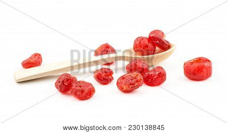 Red Dry Cherries In A Wooden Spoon And Near It Isolated On White Background
