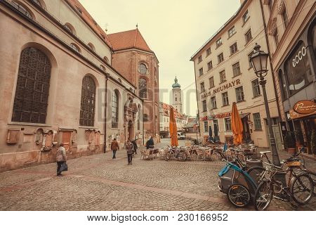Munich, Germany - November 16, 2017: People Walking In Historical City With Old Buildings, Stores An