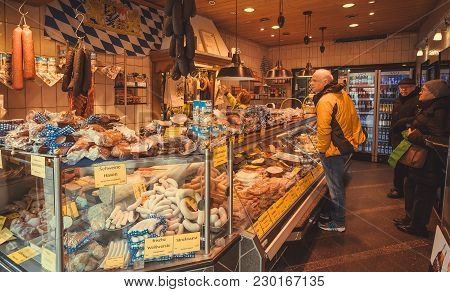 Munich, Germany - November 16, 2017: Customers Buying Bacon And Sausage In A Meat Store At Popular V