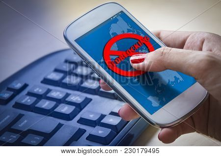 Female Hands Using A Smartphone And Being Unable To Navigate Online.geo-blocking Concept.
