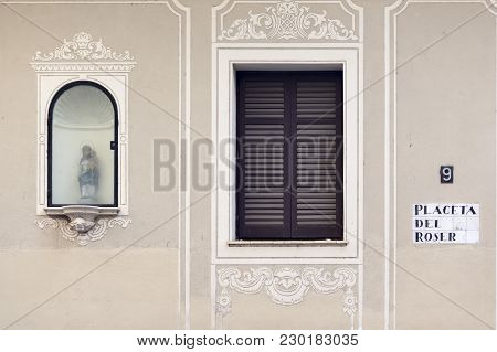 Facade Building In Neighborhood Sarria, Niche Religious Image, Window And Sign Street Placeta Del Ro