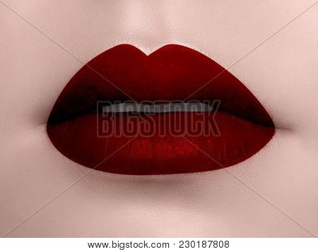 Close-up Of Woman's Lips With Bright Fashion Red Glossy Makeup. Macro Bloody Lipgloss Make-up. Cosme