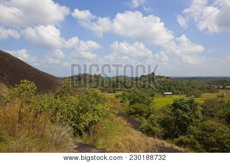 Sri Lankan Volcanic Rock In Beautiful Rural Scenery At Wasgamuwa National Park Under A Blue Sky With