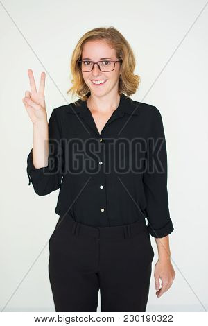 Smiling Cool Business Lady Showing Peace Sign And Looking At Camera. Cheerful Confident Woman In Eye