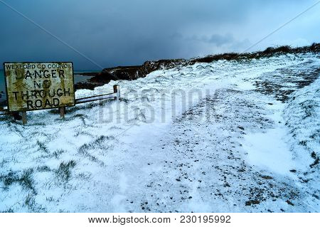 Winter Icy Road Along Cliffs Under Snow In Wexford Ireland.
