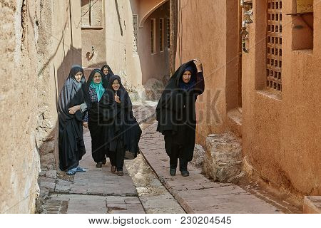 Abyaneh, Iran - April 26, 2017: Group Of Iranian Women In Hijabs Are Walking Along A Narrow Street I