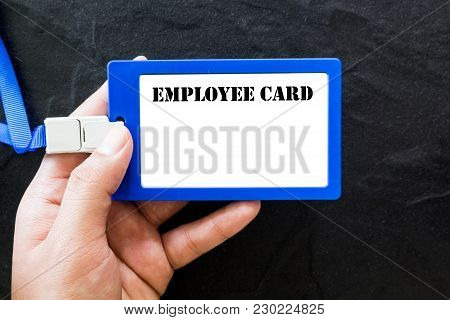 Hand Holding Emloyee Id Card On Black Background
