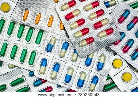 Top View Of Colorful Tablets And Capsules Pills In Blister Packs. Global Health Care And Drug Use Wi